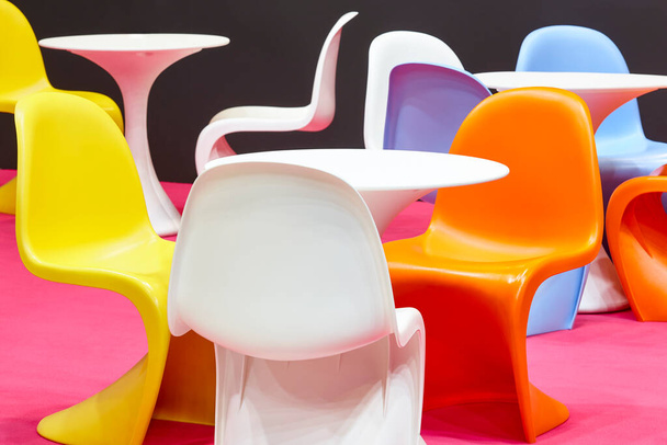Contemporary multi colored plastic chairs and tables. Kindergarten interior - 写真・画像