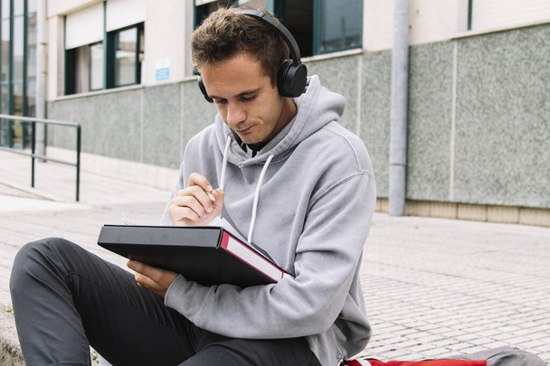 student with headphones studying in institute or university - Valokuva, kuva