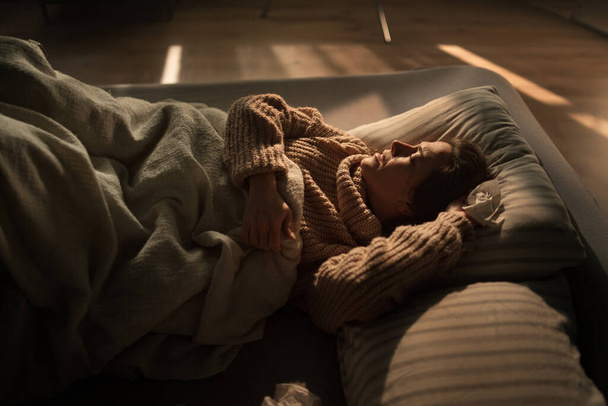 Sad woman suffering from covid depression lying in bed in night. - Zdjęcie, obraz