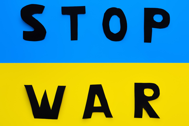 Top view of stop war lettering on ukrainian flag  - Photo, Image