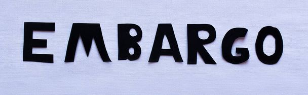 Top view of embargo lettering on white background, banner  - Foto, Imagem