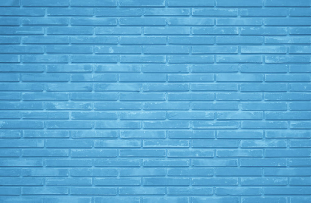 Brick wall painted with blue dark paint pastel calm tone texture background. Brickwork and stonework flooring interior rock old pattern clean concrete grid uneven bricks design stack backdrop. - Фото, изображение