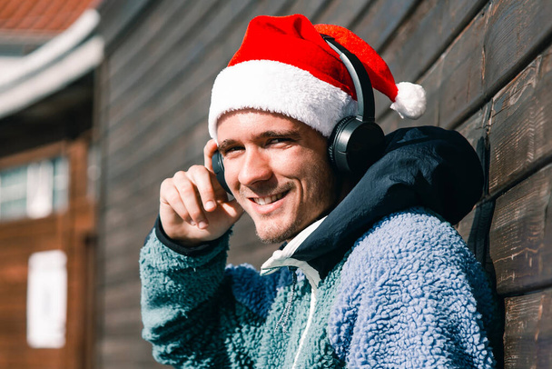 young man with christmas santa hat and headphones - Fotoğraf, Görsel