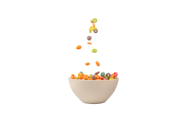 Colorful cereal box for morning breakfast. Corn flakes falling to the white bowl. Motion. Copyspace. - Valokuva, kuva