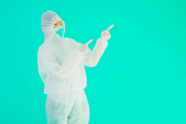 Portrait beautiful young asian doctor woman wear ppe or  personal protective equipment for protect from coronavirus or covid19 on blue isolated background - Foto, Imagem