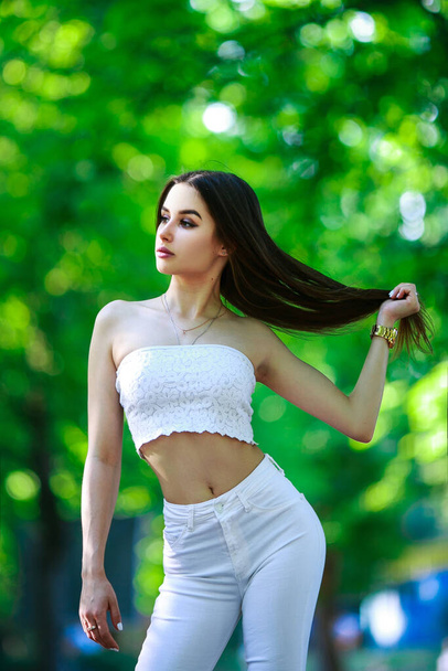 Beautiful girl in central park. All in white style. - Fotó, kép