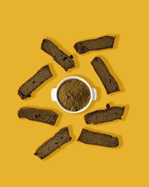 Ketogenic diet food, low carb homemade healthy sandwich made with hemp flour. Sliced bread on a yellow background. Creative minimalist composition. - Photo, Image