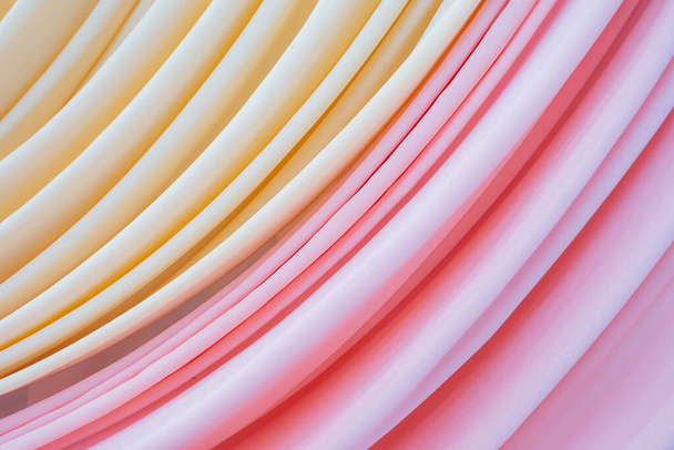Close-up van roze en lichtgele kleur gebogen gordijn textuur en abstracte achtergrond - Foto, afbeelding