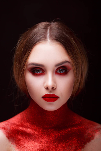 Makeup in the style of beauty. Bright lips and eyes. Portrait of a beautiful young girl. Journal detailed skin retouching. Expressive eyebrows. Huge eyelashes. Neon shadows. - 写真・画像
