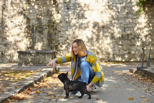 happy young woman with french bulldog outdoors - Zdjęcie, obraz