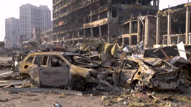 Russia war damage building destruction city war ruins city damage car. Terror attack bomb shell of civilian bombed. Disaster area. 2022 Russian invasion of Ukraine war torn city destroyed car burn out - Footage, Video