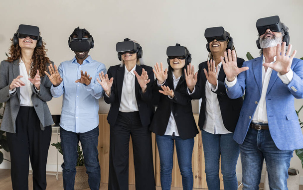 group of people of different ages office workers with virtual reality goggles - workers of the future using virtual reality - Photo, Image