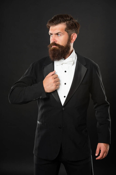 bearded bridegroom in tuxedo on black background, bow tie - Fotoğraf, Görsel