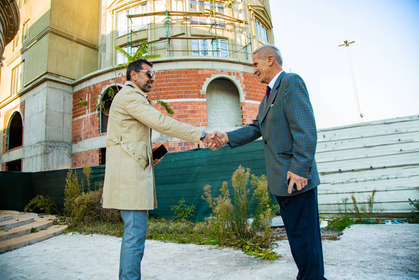 Amazing two senior buisnessmen are making a deal while smiling - Foto, Imagen