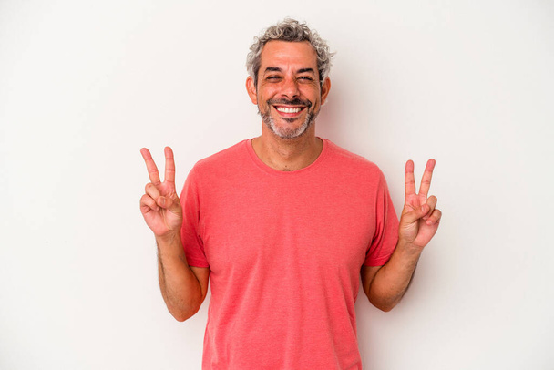 Middle age caucasian man isolated on white background  showing victory sign and smiling broadly. - Foto, imagen