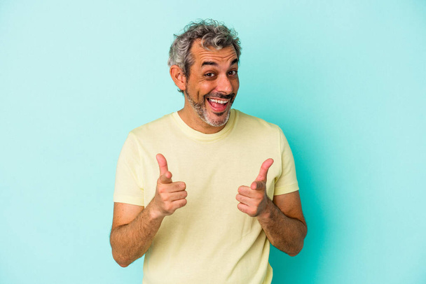 Middle age caucasian man isolated on blue background  pointing to front with fingers. - Foto, Imagem