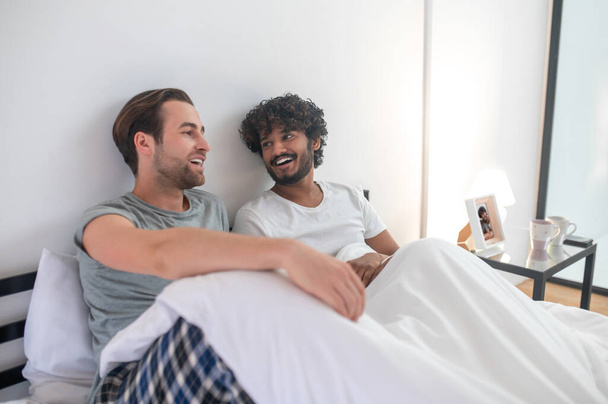 Gay couple having a talk in the bedroom - Photo, Image