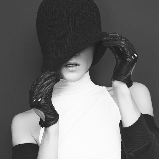 Stylish sexy model on black background in trendy gloves and jack - 写真・画像