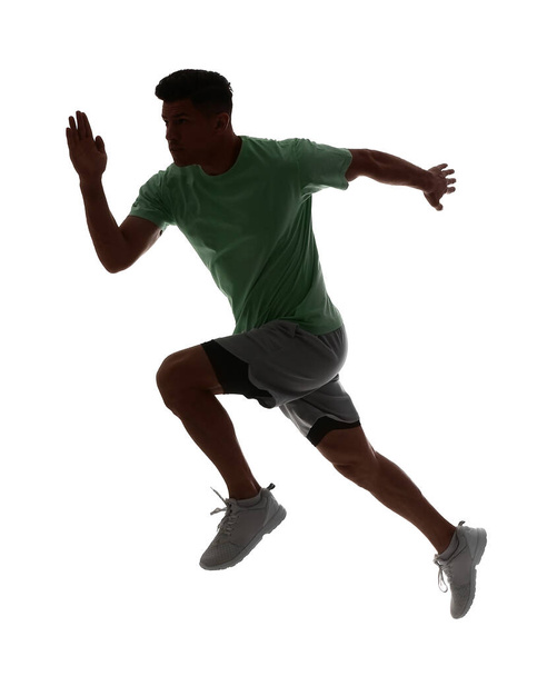 Silhouette of sporty male runner on white background - Foto, imagen