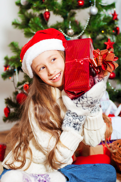 Little girl with long hair near  Christmas tree - Fotoğraf, Görsel
