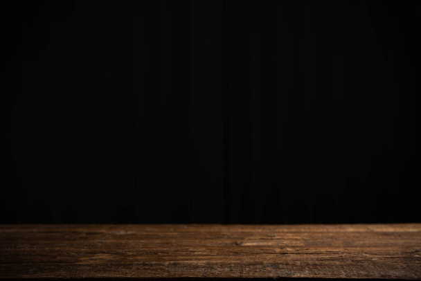 Empty wooden table on a black background - Photo, Image