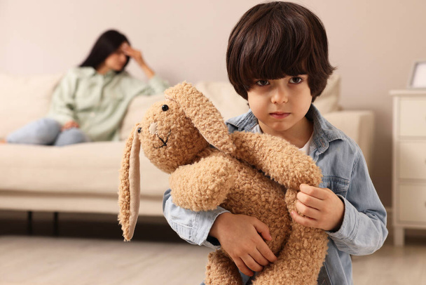Upset child with toy bunny at home - Foto, Imagem