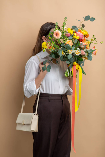portrait of woman with bunch of flowers - Photo, image