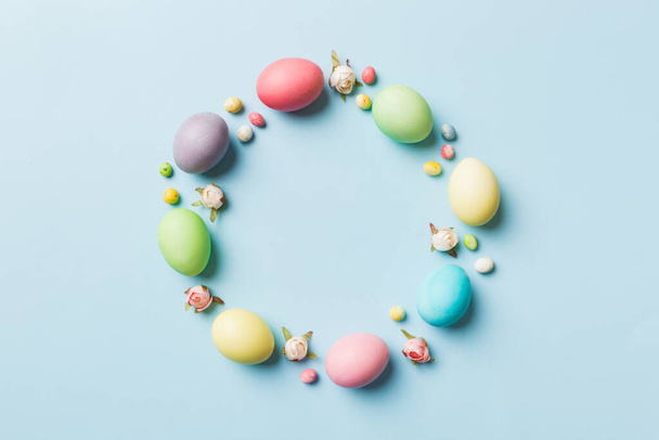 round frame Multi colors Easter eggs on colored background . Pastel color Easter eggs holiday concept with empty space for you design. - Foto, imagen