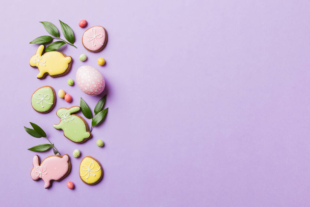 holiday preparation Multi colors Easter eggs with cookies on colored background . Pastel color Easter eggs. holiday concept with copy space. - Zdjęcie, obraz