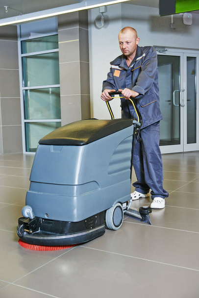 Floor care and cleaning services with machine cleaner in business centre hall - Valokuva, kuva