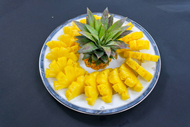 Pineapple arranged on a white plate, placed in a circle - Photo, Image