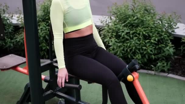 Fitness sport girl in fashion sportswear doing yoga fitness exercise on sport trendy playground on the street, outdoor sports, urban style. - Footage, Video