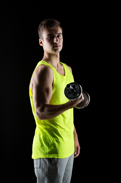young man with dumbbell - Photo, image