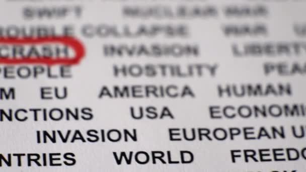 Closeup shot of ECONOMIC CRASH written on paper with a red circle around it. - Footage, Video