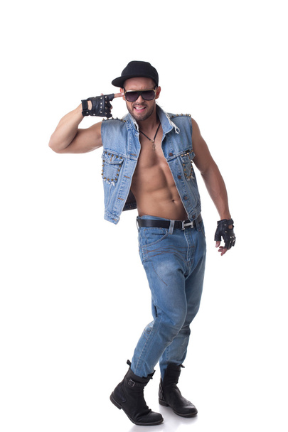 Cheerful muscular male model posing in denim suit - Photo, image