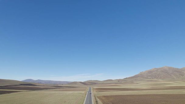 Longa estrada através dos campos rurais - Foto, Imagem