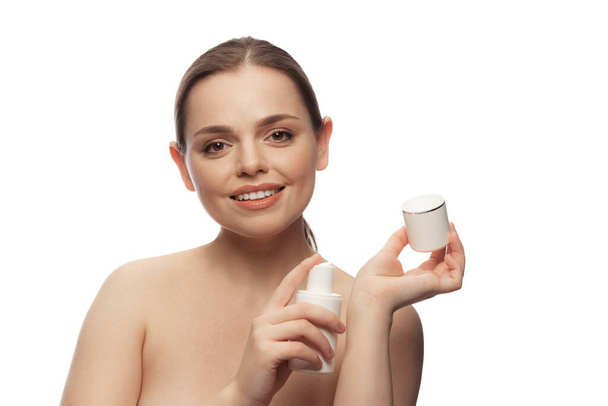 Portrait of beautiful woman with perfect smooth skin, applying face cream isolated over white studio background - Photo, Image