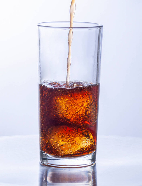Glasses of cola with ice cubes served with a splash - Foto, Imagen