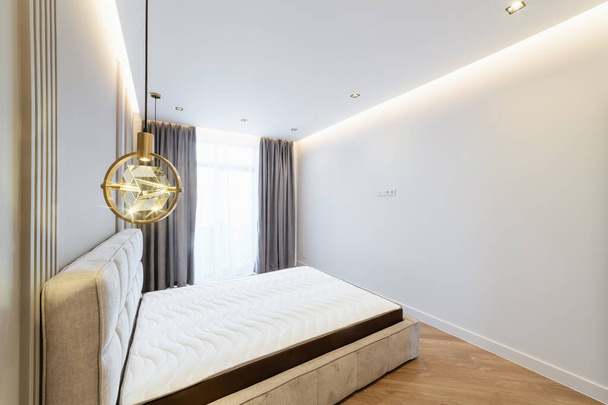 nueva cama grande limpia en una habitación nueva y luminosa - Foto, Imagen