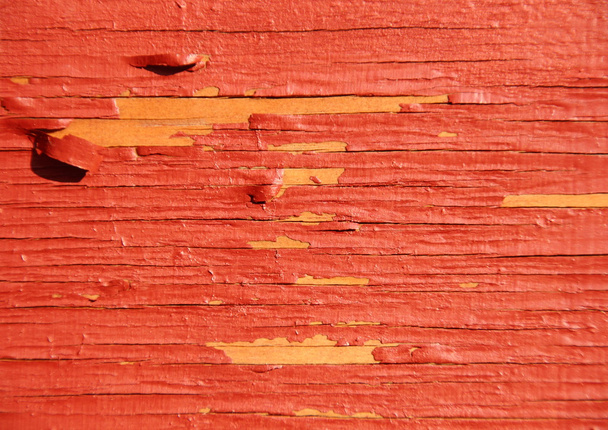 Worn yellow wood with red exfoliated paint - Foto, afbeelding