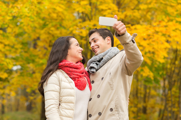 smiling couple hugging in autumn park - Foto, Imagem