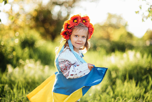 Ukrainian child with yellow and blue flag of Ukraine. flag symbol of Ukraine. Family, unity, support - Φωτογραφία, εικόνα