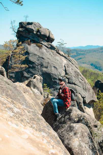 man hiker with backpack at dovbush rocks landscape - Фото, изображение