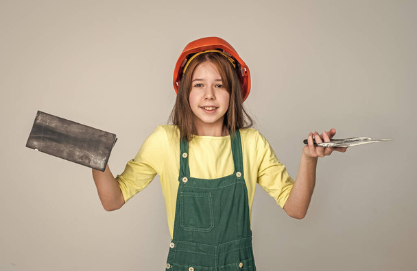 labor day. plasterer. teen girl in uniform and helmet. female builder in hard hat. - Foto, Bild