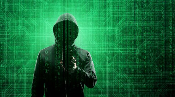 Computer Hacker in Hoodie. Obscured Dark Face. Hacker Attack, Virus Infected Software, Dark Web and Cyber Security Concept . - 写真・画像