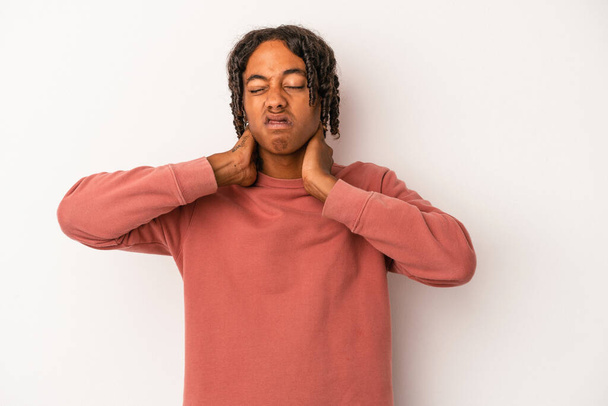 Jeune homme afro-américain isolé sur fond blanc souffrant de douleurs au cou dues à un mode de vie sédentaire. - Photo, image