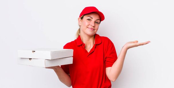 blonde pretty woman feeling puzzled and confused and doubting. pizza delivery concept - Valokuva, kuva