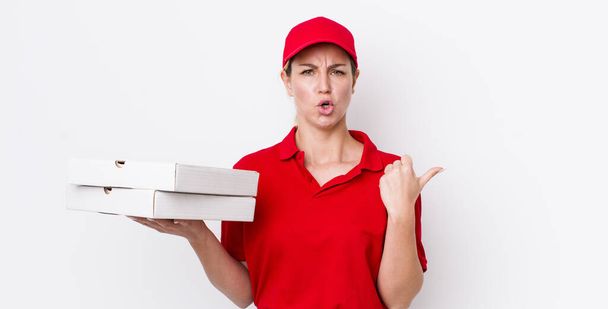 blonde pretty woman looking astonished in disbelief. pizza delivery concept - Φωτογραφία, εικόνα