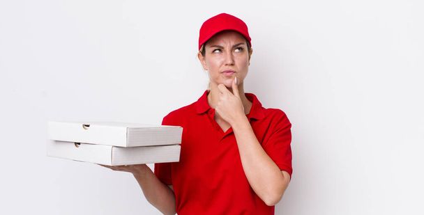 blonde pretty woman thinking, feeling doubtful and confused. pizza delivery concept - Φωτογραφία, εικόνα