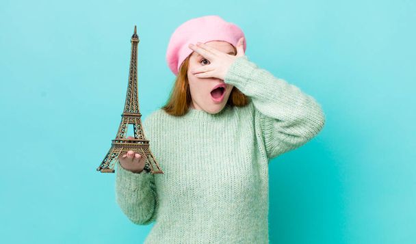 red head pretty woman looking shocked, scared or terrified, covering face with hand. france concept - Photo, Image